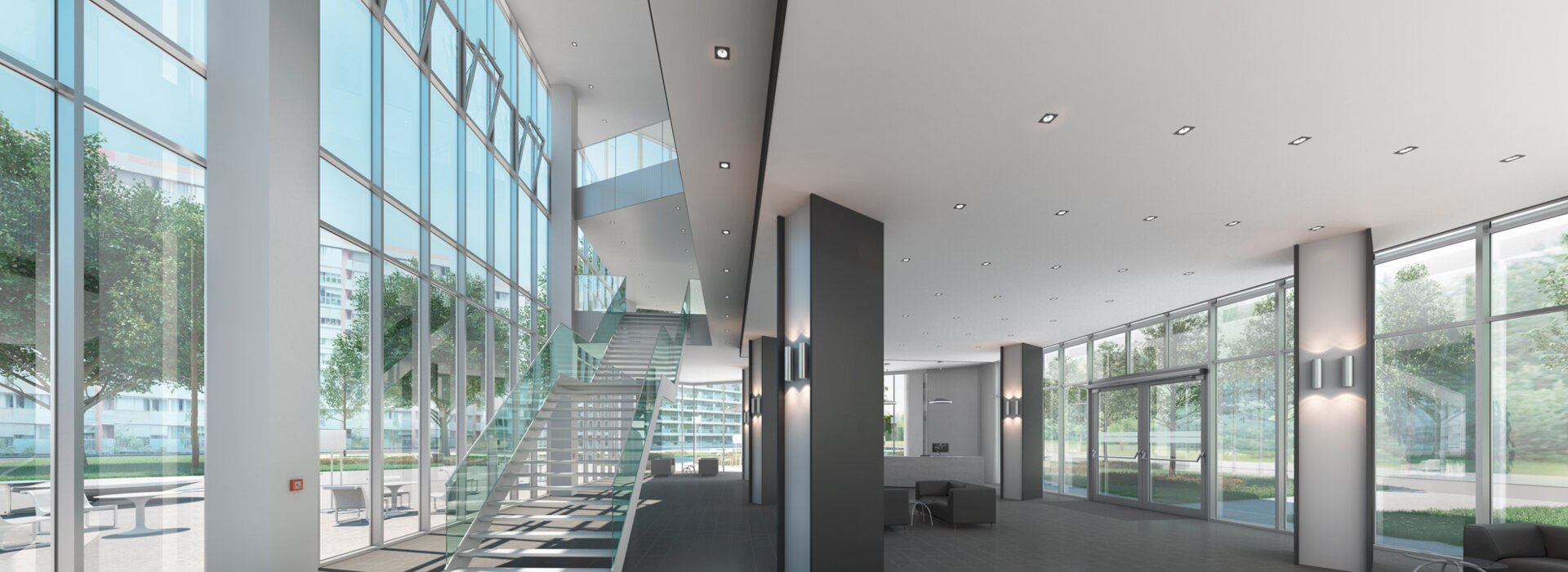 RWA-Anlage im modernen, lichtdurchfluteten Eingangsbereich eines Bürogebäudes mit Glasfassade und Treppe