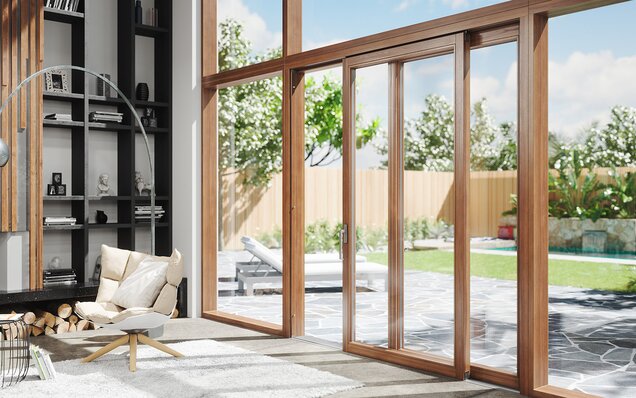 Moderner Wohnraum mit großer Hebeschiebetür aus Holz und Gartenblick